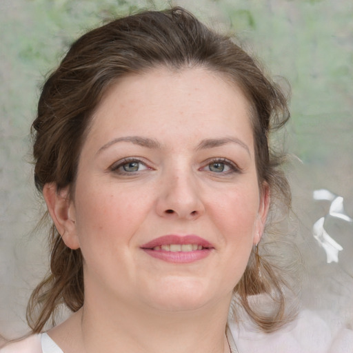 Joyful white adult female with medium  brown hair and grey eyes