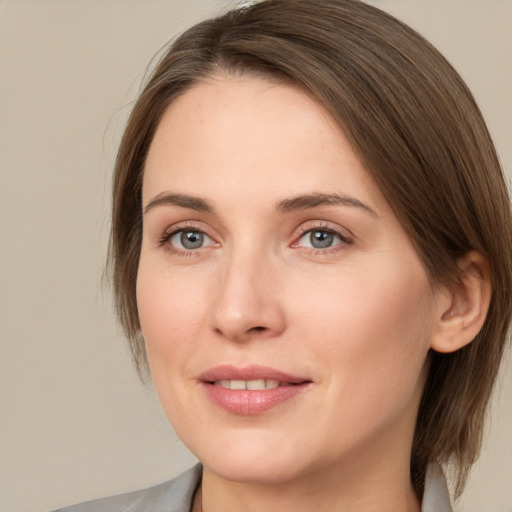 Joyful white young-adult female with medium  brown hair and grey eyes