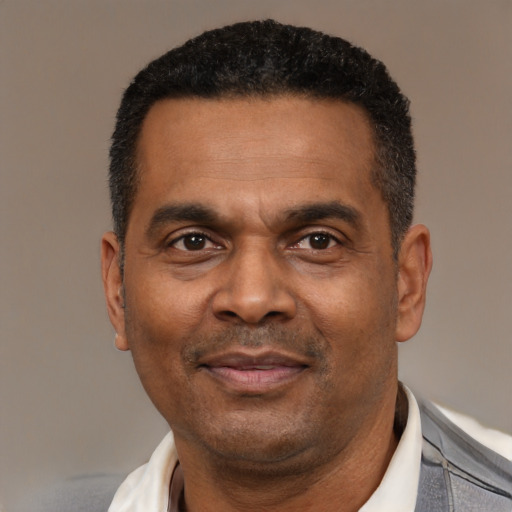 Joyful latino adult male with short  black hair and brown eyes