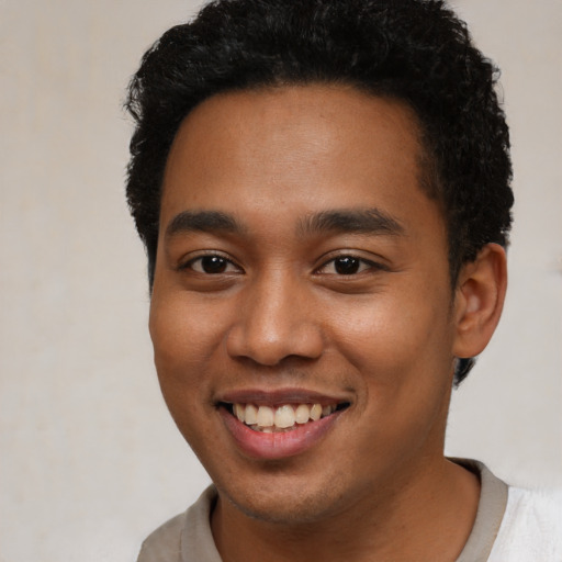 Joyful latino young-adult male with short  brown hair and brown eyes