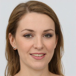 Joyful white young-adult female with long  brown hair and green eyes