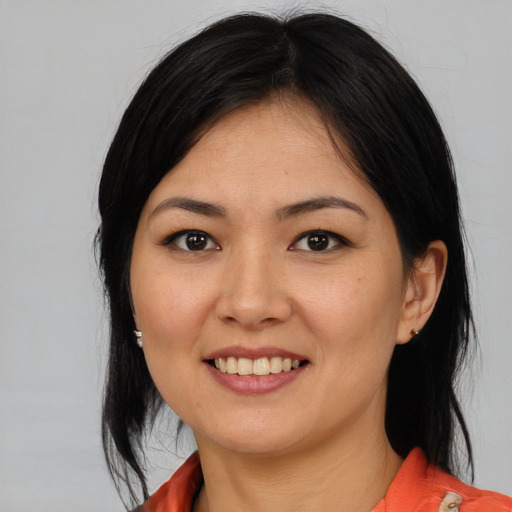 Joyful asian young-adult female with medium  brown hair and brown eyes