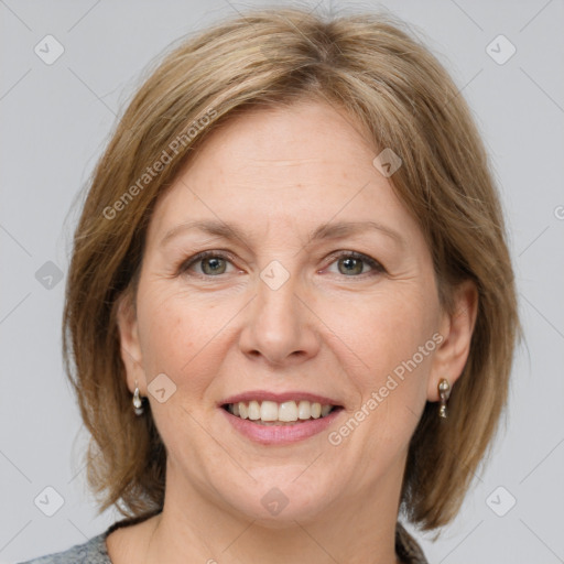 Joyful white adult female with medium  brown hair and grey eyes