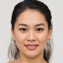 Joyful asian young-adult female with medium  brown hair and brown eyes