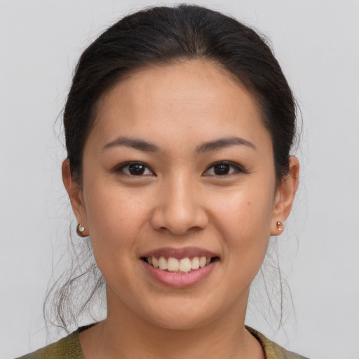 Joyful asian young-adult female with medium  brown hair and brown eyes