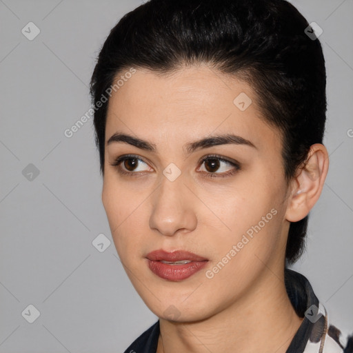 Joyful latino young-adult female with short  black hair and brown eyes