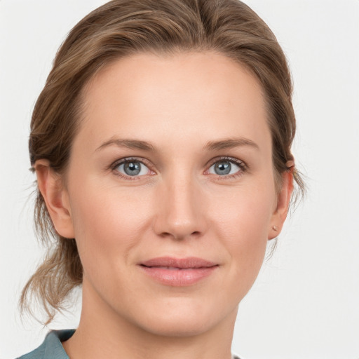 Joyful white young-adult female with medium  brown hair and blue eyes