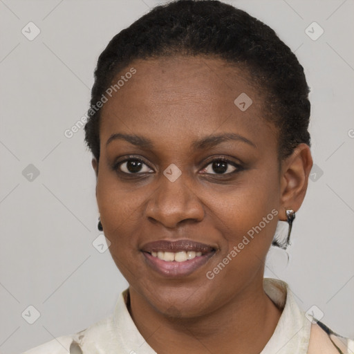 Joyful black young-adult female with short  black hair and brown eyes