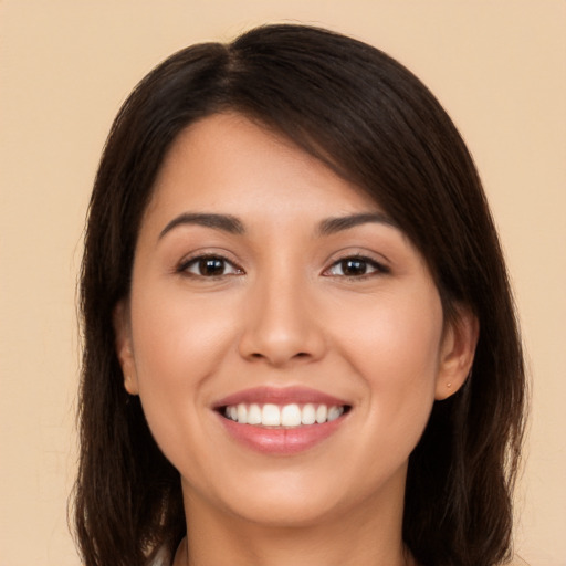 Joyful white young-adult female with long  brown hair and brown eyes