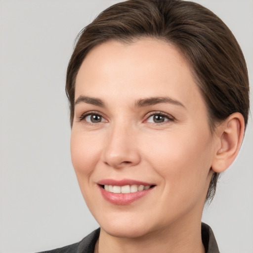 Joyful white young-adult female with medium  brown hair and brown eyes