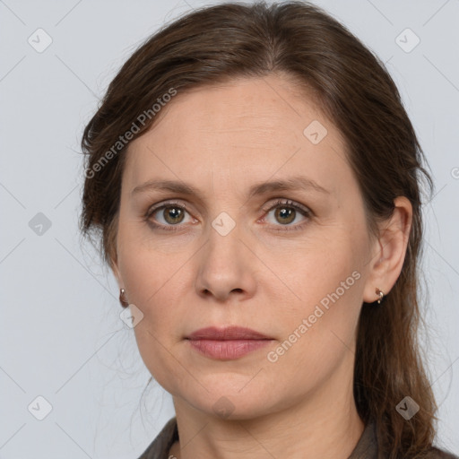 Joyful white adult female with long  brown hair and grey eyes