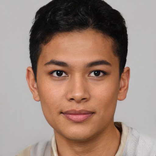 Joyful asian young-adult male with short  brown hair and brown eyes