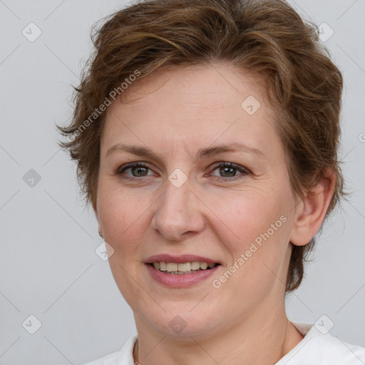 Joyful white adult female with medium  brown hair and grey eyes