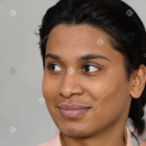 Joyful black young-adult female with medium  brown hair and brown eyes