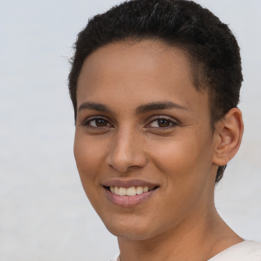 Joyful latino young-adult female with short  brown hair and brown eyes