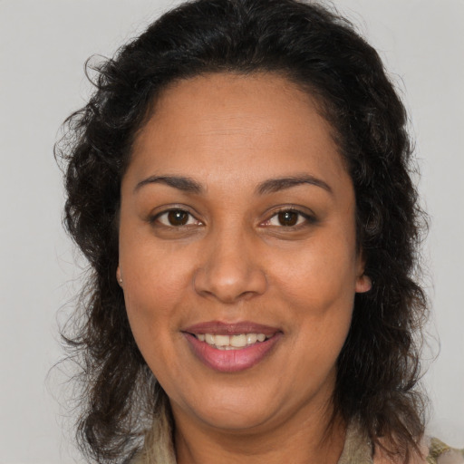 Joyful white adult female with medium  brown hair and brown eyes
