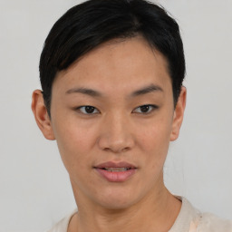 Joyful asian young-adult female with short  black hair and brown eyes