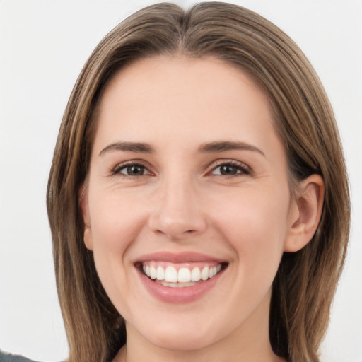 Joyful white young-adult female with long  brown hair and grey eyes