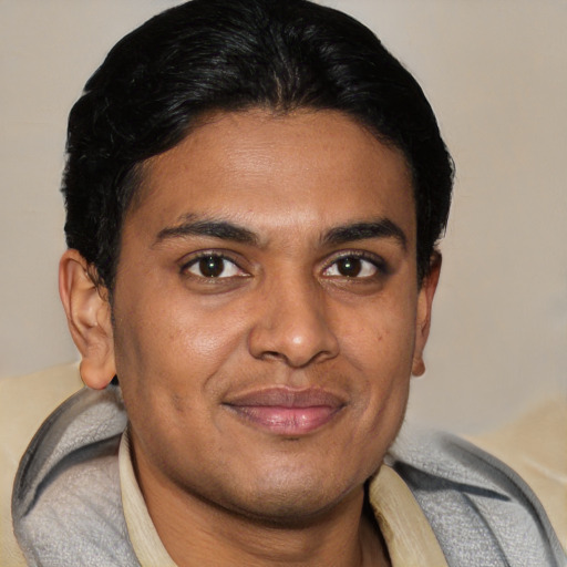 Joyful latino young-adult male with short  brown hair and brown eyes