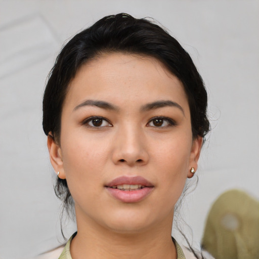 Joyful asian young-adult female with short  black hair and brown eyes