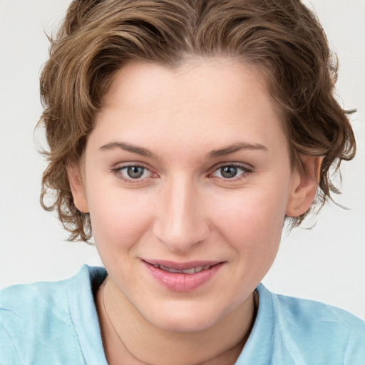 Joyful white young-adult female with medium  brown hair and blue eyes