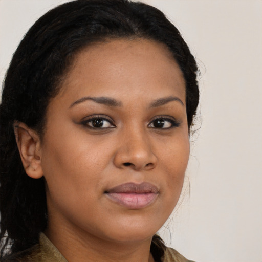 Joyful black young-adult female with long  brown hair and brown eyes