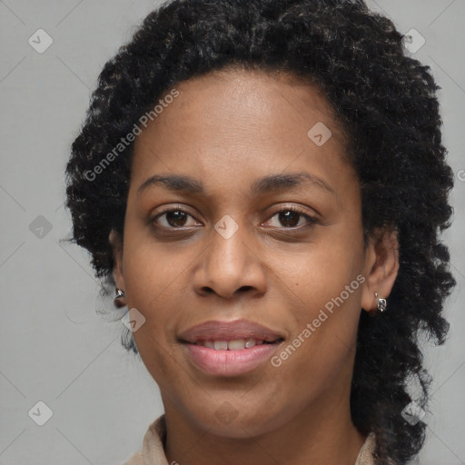 Joyful black young-adult female with long  black hair and brown eyes