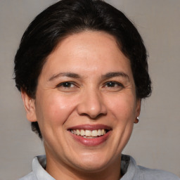 Joyful white adult female with short  brown hair and brown eyes