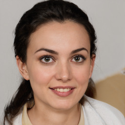 Joyful white young-adult female with medium  brown hair and brown eyes