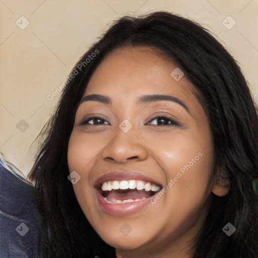 Joyful latino young-adult female with long  black hair and brown eyes