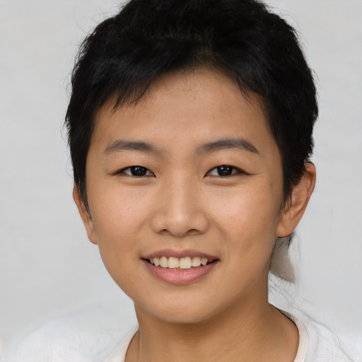Joyful asian young-adult female with short  black hair and brown eyes