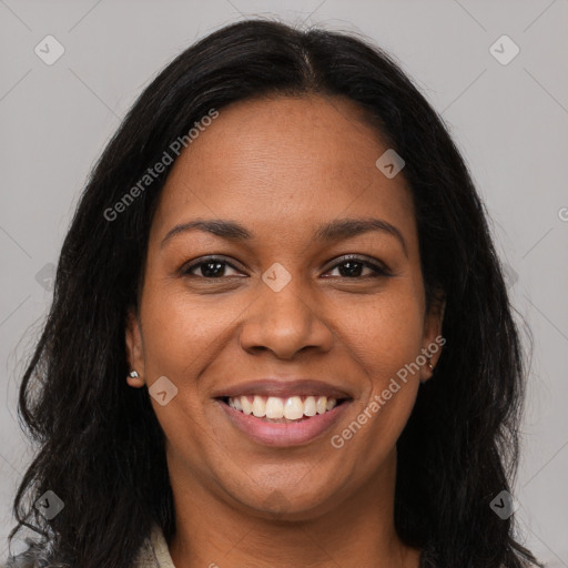 Joyful black young-adult female with long  brown hair and brown eyes