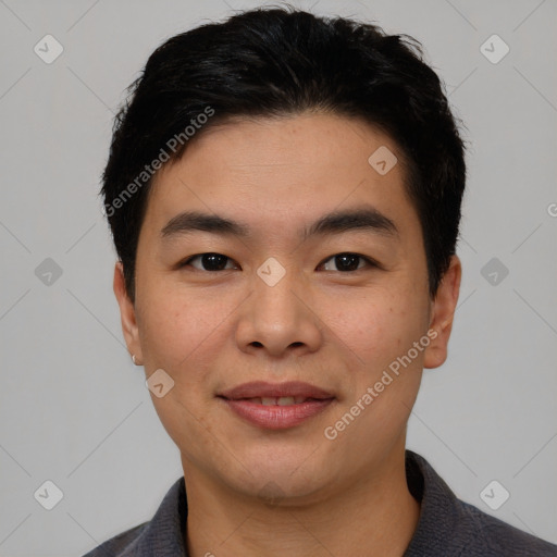 Joyful asian young-adult male with short  black hair and brown eyes