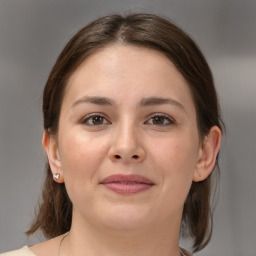 Joyful white young-adult female with medium  brown hair and brown eyes