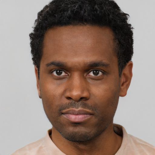 Neutral black young-adult male with short  black hair and brown eyes