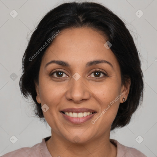 Joyful latino adult female with medium  brown hair and brown eyes