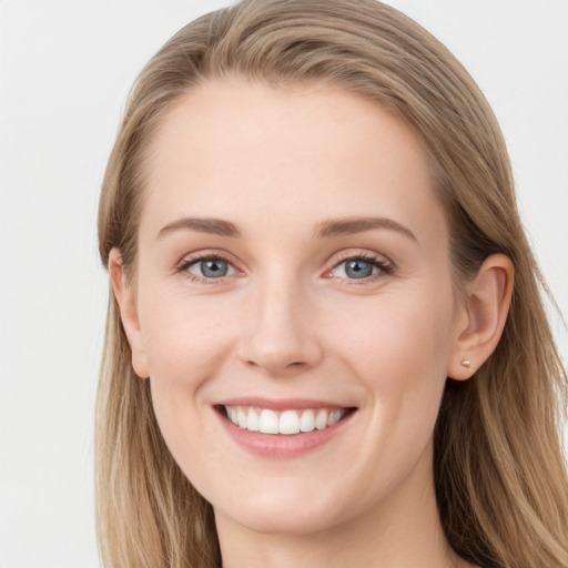 Joyful white young-adult female with long  brown hair and blue eyes