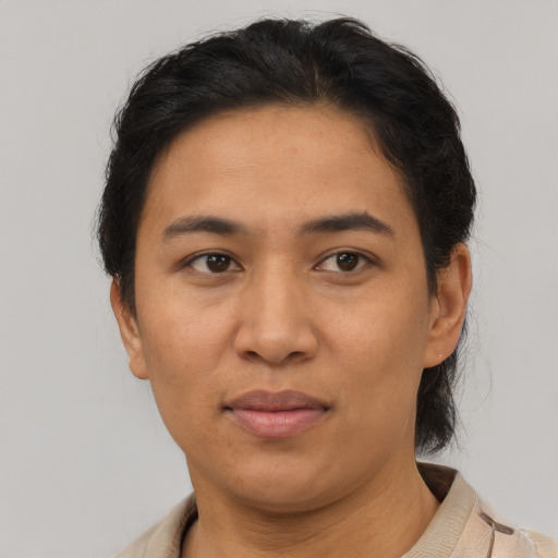 Joyful asian adult female with short  brown hair and brown eyes