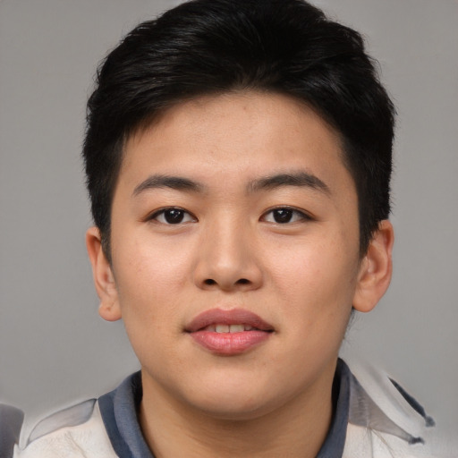 Joyful asian young-adult male with short  brown hair and brown eyes