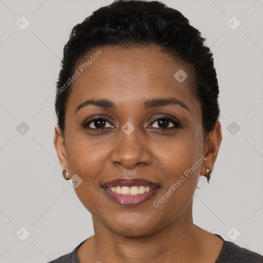 Joyful black young-adult female with short  black hair and brown eyes