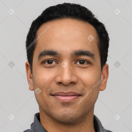 Joyful latino young-adult male with short  black hair and brown eyes