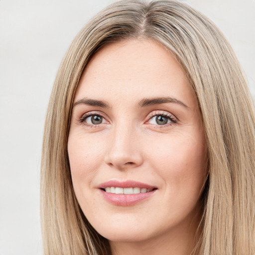 Joyful white young-adult female with long  brown hair and green eyes