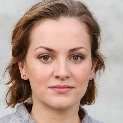 Joyful white young-adult female with medium  brown hair and blue eyes