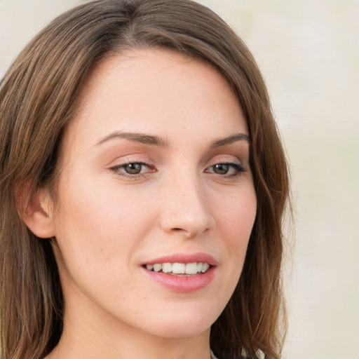 Joyful white young-adult female with long  brown hair and green eyes