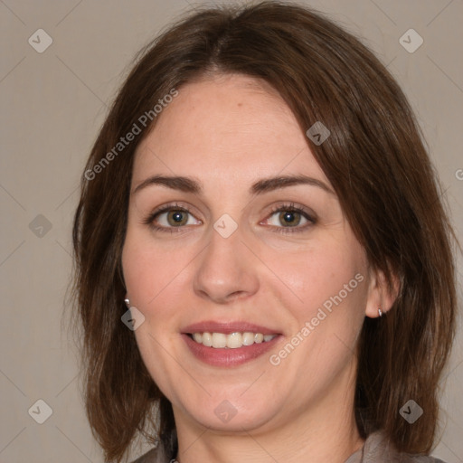 Joyful white adult female with medium  brown hair and green eyes