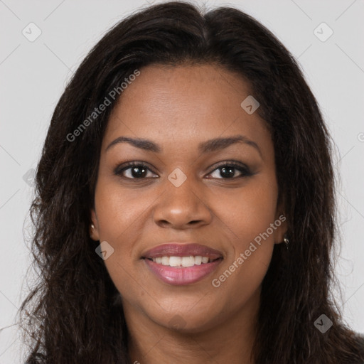 Joyful black young-adult female with long  brown hair and brown eyes