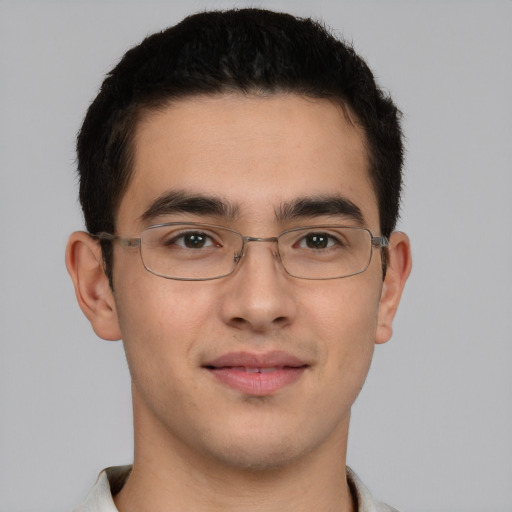 Joyful latino young-adult male with short  brown hair and brown eyes