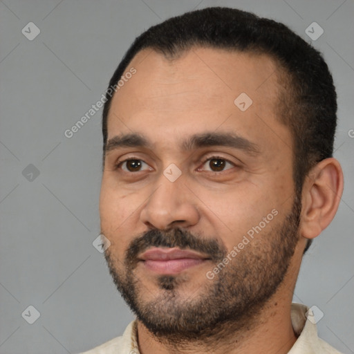 Joyful latino adult male with short  black hair and brown eyes