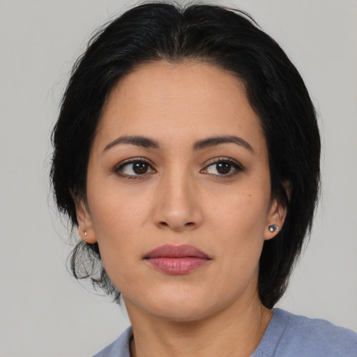 Joyful latino young-adult female with medium  black hair and brown eyes