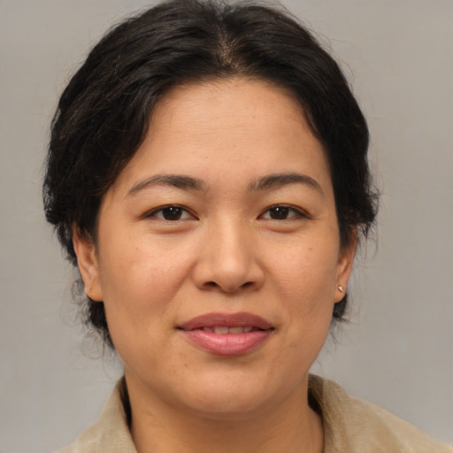 Joyful asian adult female with medium  brown hair and brown eyes